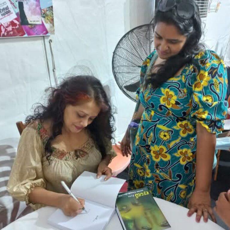 Tharu Queen Tharaka Wasalamudaliarachchi singing an autograph to a fan