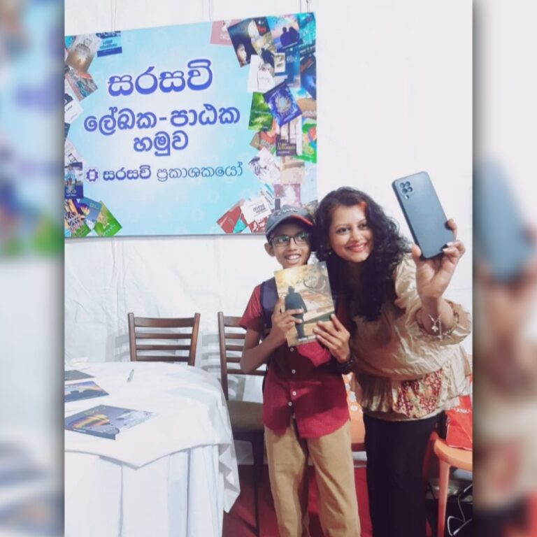 Tharu Queen Tharaka Wasalamudaliarachchi taking a selfie with one of her fans